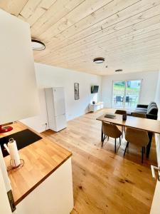 a kitchen and living room with a wooden ceiling at FeWo 1 Heudorfer in Schlier
