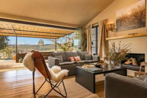 a living room with a couch and a table at Discreet Luxury Home With Splendid Views in La Cimada