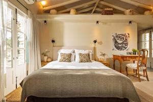 a bedroom with a large bed and a desk at Discreet Luxury Home With Splendid Views in La Cimada +20 photos