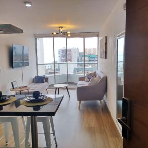 a living room with a couch and chairs and a table at Vive y trabaja con estilo en San Miguel, moderno departamento de 2 dorms con balcon in Lima