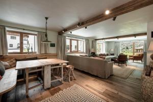 a living room with a couch and a table at Chalet Cecilia by MYALPS in Obergurgl