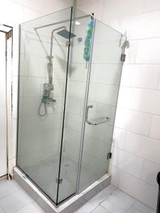 a shower with a glass door in a bathroom at Share with Jayz in Lekki