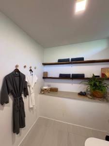 a room with clothes hanging on a wall at Villa Verde Ko Phangan in Haad Pleayleam