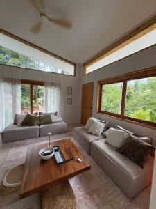 a living room with a couch and a table at Villa Verde Ko Phangan in Haad Pleayleam