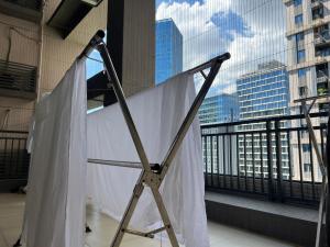 a white curtain on a stand on a balcony at Shenzhen Beacon Hostel in Shenzhen