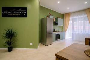 a kitchen with a refrigerator in a green wall at 4 Seasons Roma Trastevere in Rome