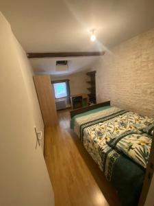 a bedroom with a bed in a room at Charmante Maison dans village calme in Chef-Boutonne +5 photos