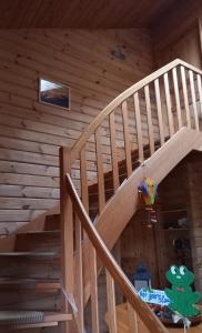 a wooden staircase in a log cabin at FeWo Wardersee in Rohlstorf