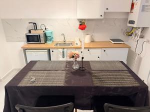 a small kitchen with a table and a sink at JAD Militari Residence in Roşu +2 photos