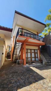 a house with a staircase in front of it at Teala Villa in Mantaak