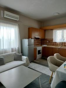 a living room with a couch and a refrigerator at Stylish Modern Flat in Pyrgos near Olympia in Pýrgos
