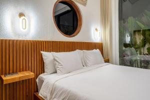 een slaapkamer met een wit bed en een spiegel bij Oasis Pandawa 1A - Just Built! Perfect Getaway Villa with Pool in Ungasan +2 foto's