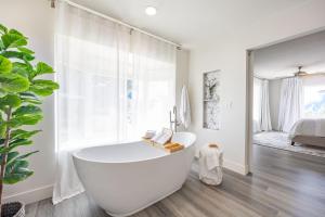 a white bath tub in a bathroom with a window at BytheSea Bluff Retreat Ocean Views & Coastal Trails in Seal Cove