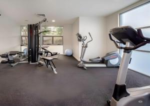 a gym with treadmills and exercise bikes in a room at Studio Lagoon Apartment in Salamander Bay
