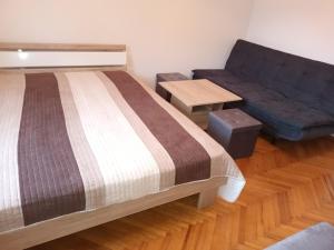 a bedroom with a bed and a couch at Apartment Carmen in Brezje +18 photos