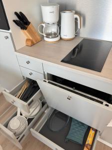 a kitchen with a counter top with a drawer at RD Apartments - Areenan Lumo in Tampere +5 photos