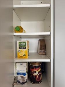 a refrigerator with some food items on the shelves at RD Apartments - Areenan Lumo in Tampere