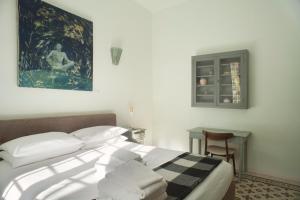 a bedroom with a bed and a table and a window at Urban jungle in Bologna