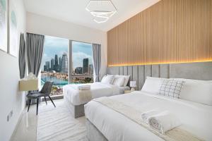a hotel room with two beds and a large window at The Grande Signature Experience Modern 2BR with Incredible Views of Burj Khalifa & Dubai Fountain, Steps Away from Dubai Mall in Dubai +74 photos