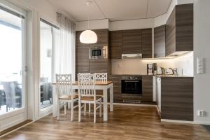 a kitchen with a table and chairs in a room at Meritähti 104 in Kalajoki