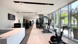 a gym with treadmills and exercise equipment in a building at The Grande Signature Experience Modern 2BR with Incredible Views of Burj Khalifa & Dubai Fountain, Steps Away from Dubai Mall in Dubai