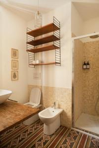 a bathroom with a sink and a toilet and a shower at Urban jungle in Bologna +65 photos