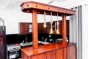 a wooden stand in a kitchen with a counter at Kyali Homestay Tangalle in Tangalle