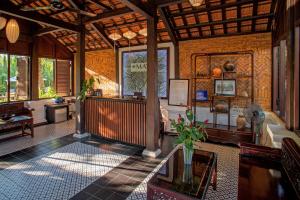 a lobby of a resort with a couch and a table at Mayci Eco Boutique Hotel Hoi An in Hoi An