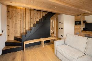 a living room with a staircase and a couch at Chalet Silene in Livigno