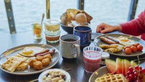 a table topped with plates of breakfast foods and drinks at Go Nordic Cruiseline MiniCruise Oslo - Copenhagen - Oslo in Oslo