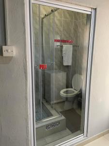 a bathroom with a shower with a toilet in it at The Siblings Legacy Hotel in Palatswe +4 photos