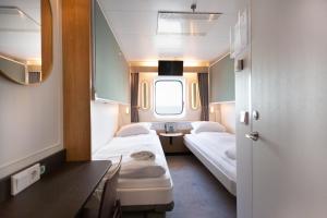 a small room with two beds and a window at Go Nordic Cruiseline MiniCruise Oslo - Copenhagen - Oslo in Oslo +9 photos