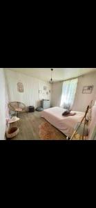 a bedroom with a large bed and a table at Appartement 140 m2 centre ville le Creusot in Le Creusot