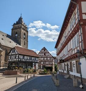 a city street with buildings and a clock tower at Altes Rathaus Kassel-Wolfhagen in Wolfhagen