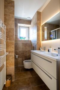 a bathroom with a sink and a toilet at Lovely House in Besançon +49 photos