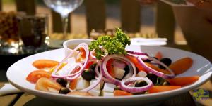 a plate of food with vegetables on a table at Rättviks Golfby in Rättvik +11 photos