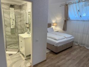 a bedroom with a bed and a shower and a sink at Silvan Villa - Apart in Sighişoara +105 photos
