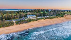 an aerial view of a house on the beach at KozyGuru | Chittaway Point | Lakeside Luxe Retreat in Chittaway Point