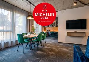 塞格德Noir Hotel的一间会议室,配有桌子和绿色椅子