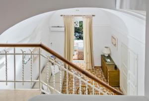 a staircase leading to a door in a house at Villa Mariuccia Capri in Capri