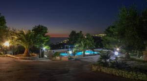 a villa with a swimming pool at night at B&B Villa Nicoletta in Peschici