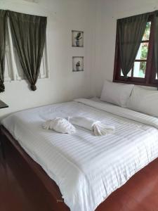a large white bed with two white pillows on it at Laem Klong sae view in Koh Tao +70 photos
