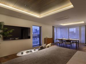 a bedroom with a bed and a dining room with a table at 30 PIECES Namba in Osaka +23 photos