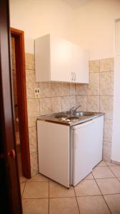 a kitchen with a sink and a white refrigerator at Apartaments A4 in Ulcinj +81 photos