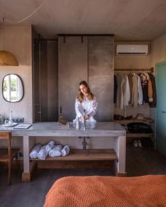 a woman sitting at a large table in a room at Azenhas do Mar Valley House in Sintra