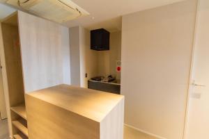 a kitchen with a wooden counter top in a room at Visionary Stay HINODE in Tokyo +5 photos
