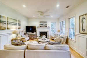 a living room with a couch and a fireplace at OG14: 14 Ocean Green in Kiawah Island