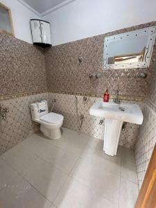 a bathroom with a sink and a toilet at Umda Hotel Galaxy in Dargai
