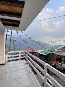 a balcony with a white railing on a building at Umda Hotel Galaxy in Dargai +11 photos
