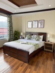 a bedroom with a large bed and a window at Umda Hotel Galaxy in Dargai